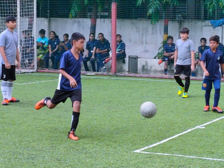 Students playing football on a school field